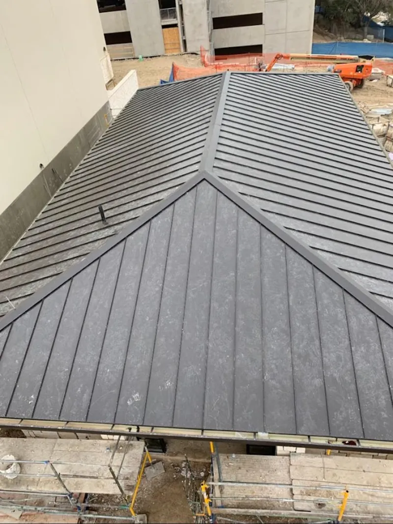 Commercial metal roof construction with crane equipment in World Golf Village