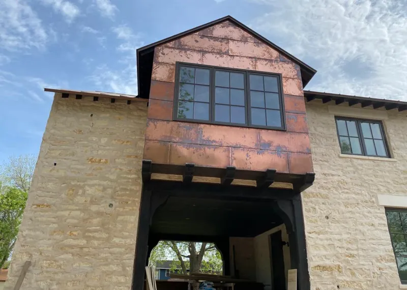 Copper metal panel facade on a stone building for Skylight Installation in World Golf Village